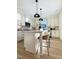 Bright kitchen boasting white cabinetry, stainless steel appliances, and a stylish island at 960 Double Helix Rd, Apex, NC 27523