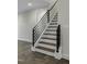 Close up of staircase with modern black railing and wood steps at 960 Double Helix Rd, Apex, NC 27523