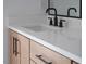 Close up of the bright bathroom vanity featuring quartz counters and black hardware at 970 Double Helix Rd, Apex, NC 27523