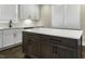 Contemporary kitchen features white cabinets, quartz countertops, an island with dark wood storage, and natural light at 970 Double Helix Rd, Apex, NC 27523