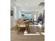 Bright and airy living area with natural light, hardwood floors, dining table and a staircase in the background at 970 Double Helix Rd, Apex, NC 27523