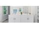 Bright bathroom with a double vanity, white cabinets, and a large mirror at 98 Beach Ln, Henderson, NC 27537