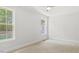 Bright bedroom features neutral walls, carpet, trim, and windows at 98 Beach Ln, Henderson, NC 27537