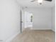 Clean bedroom with carpet flooring and view to another bedroom through the door at 98 Beach Ln, Henderson, NC 27537