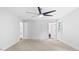 Spacious bedroom featuring neutral walls, carpet, trim, windows, and ceiling fan at 98 Beach Ln, Henderson, NC 27537