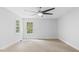 Bright bedroom with neutral walls, carpet, trim, windows, and ceiling fan at 98 Beach Ln, Henderson, NC 27537