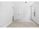 Bright bedroom features neutral walls, carpet, trim, and a closet at 98 Beach Ln, Henderson, NC 27537