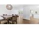 Spacious dining area adjacent to the kitchen, featuring a modern light fixture and wood floors at 98 Beach Ln, Henderson, NC 27537