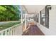 Charming front porch with white railings and wood flooring, offering a cozy welcome at 98 Beach Ln, Henderson, NC 27537