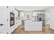 Modern kitchen with white cabinets, stainless steel appliances, and an island cooktop at 98 Beach Ln, Henderson, NC 27537