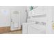 Well-lit laundry room featuring a washer, dryer, white cabinets, and access to the exterior at 98 Beach Ln, Henderson, NC 27537