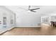 Bright, open living room with wood floors and a ceiling fan at 98 Beach Ln, Henderson, NC 27537