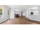 Bright living room featuring hardwood floors, dining area, and a view into the kitchen at 98 Beach Ln, Henderson, NC 27537