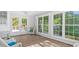 Bright sunroom features large windows, wicker chairs, and double doors to the deck at 98 Beach Ln, Henderson, NC 27537