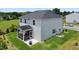 Aerial view of backyard with patio, screened-in porch and lush landscaping at 10 Forest Brook Way, Clayton, NC 27520