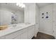 Bright bathroom with double vanity sinks, white cabinets, and modern lighting at 10 Forest Brook Way, Clayton, NC 27520