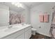 Stylish bathroom featuring double sinks, a large mirror, and a neutral shower curtain at 10 Forest Brook Way, Clayton, NC 27520