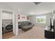 Large bonus room featuring a leather sectional sofa and convenient access to the laundry room at 10 Forest Brook Way, Clayton, NC 27520