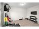 Home gym boasts free weights, weight machine, and a wall-mounted television at 10 Forest Brook Way, Clayton, NC 27520