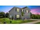 Inviting home with well-lit exterior, showcasing a lush lawn and an attached two-car garage at 10 Forest Brook Way, Clayton, NC 27520
