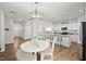 Bright kitchen with eat-in area, showcasing modern pendant lighting and a view of the living space at 10 Forest Brook Way, Clayton, NC 27520