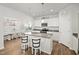 Well-lit kitchen with granite island, modern appliances, and an adjacent dining area for casual meals at 10 Forest Brook Way, Clayton, NC 27520