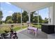 Enclosed porch features ceiling fan, table and chairs, and a view of the backyard at 10 Forest Brook Way, Clayton, NC 27520