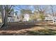 Spacious backyard with mature trees, a wooden fence, and manicured lawn at 1007 Olde Midway Ct, Knightdale, NC 27545