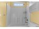 Full view of a bathroom with a tub/shower combo featuring white tile walls at 1007 Olde Midway Ct, Knightdale, NC 27545