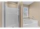 Bathroom featuring glass enclosed shower and a jetted soaking tub at 1007 Olde Midway Ct, Knightdale, NC 27545