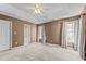 Bright bedroom showcasing tray ceilings and multiple windows, next to the en-suite bath at 1007 Olde Midway Ct, Knightdale, NC 27545