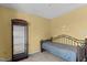 Cozy bedroom featuring carpet floors, yellow walls, and a metal-framed bed at 1007 Olde Midway Ct, Knightdale, NC 27545