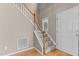 Inviting entryway featuring hardwood floors, a staircase, and a stylish design at 1007 Olde Midway Ct, Knightdale, NC 27545