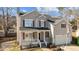 Beautiful two-story home featuring a cozy front porch and attached two car garage at 1007 Olde Midway Ct, Knightdale, NC 27545