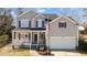 Charming home featuring a covered front porch, attached garage, and neat landscaping at 1007 Olde Midway Ct, Knightdale, NC 27545