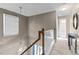 Bright hallway with a pendant light, window and white railing at 1007 Olde Midway Ct, Knightdale, NC 27545