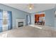 Spacious living room with a fireplace, large windows, and a dining area view at 1007 Olde Midway Ct, Knightdale, NC 27545