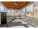 Inviting screened porch with ceiling fan, furniture, and view of backyard deck at 1007 Olde Midway Ct, Knightdale, NC 27545