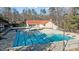 Aerial view of large community pool with lane markers and a clubhouse in the background at 1007 Olde Midway Ct, Knightdale, NC 27545