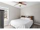 Cozy bedroom features a ceiling fan, wood-look flooring, and a natural light filled window at 1033 Forest Glen Dr, Raleigh, NC 27603