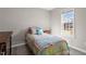 Comfortable bedroom features a window with natural light and wood-look flooring at 1033 Forest Glen Dr, Raleigh, NC 27603