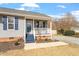 Attractive single-story home featuring a cozy porch with decorative touches and neatly landscaped flower beds at 1033 Forest Glen Dr, Raleigh, NC 27603