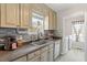 Well-lit kitchen featuring a stainless steel sink and tiled backsplash at 1033 Forest Glen Dr, Raleigh, NC 27603
