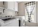 Laundry room equipped with modern washer and dryer with bright natural light at 1033 Forest Glen Dr, Raleigh, NC 27603