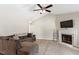 Cozy living room with hardwood floors, ceiling fan, fireplace, and comfortable sectional sofa at 1033 Forest Glen Dr, Raleigh, NC 27603