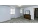 A carpeted bedroom with a dresser and multiple windows providing ample natural light at 104 Province Cir, Rocky Mount, NC 27804