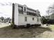 Charming home featuring white siding, a brick chimney, dormer windows, and mature trees at 104 Province Cir, Rocky Mount, NC 27804