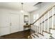 Inviting foyer featuring hardwood floors, a staircase, a stylish pendant light, and decorative molding at 104 Province Cir, Rocky Mount, NC 27804