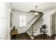 Entryway with staircase featuring carpeted steps, white railings, and hardwood floors at 104 Province Cir, Rocky Mount, NC 27804
