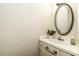 Cozy half-bathroom with stylish wallpaper, vanity, mirror, and a decorative plant at 104 Province Cir, Rocky Mount, NC 27804